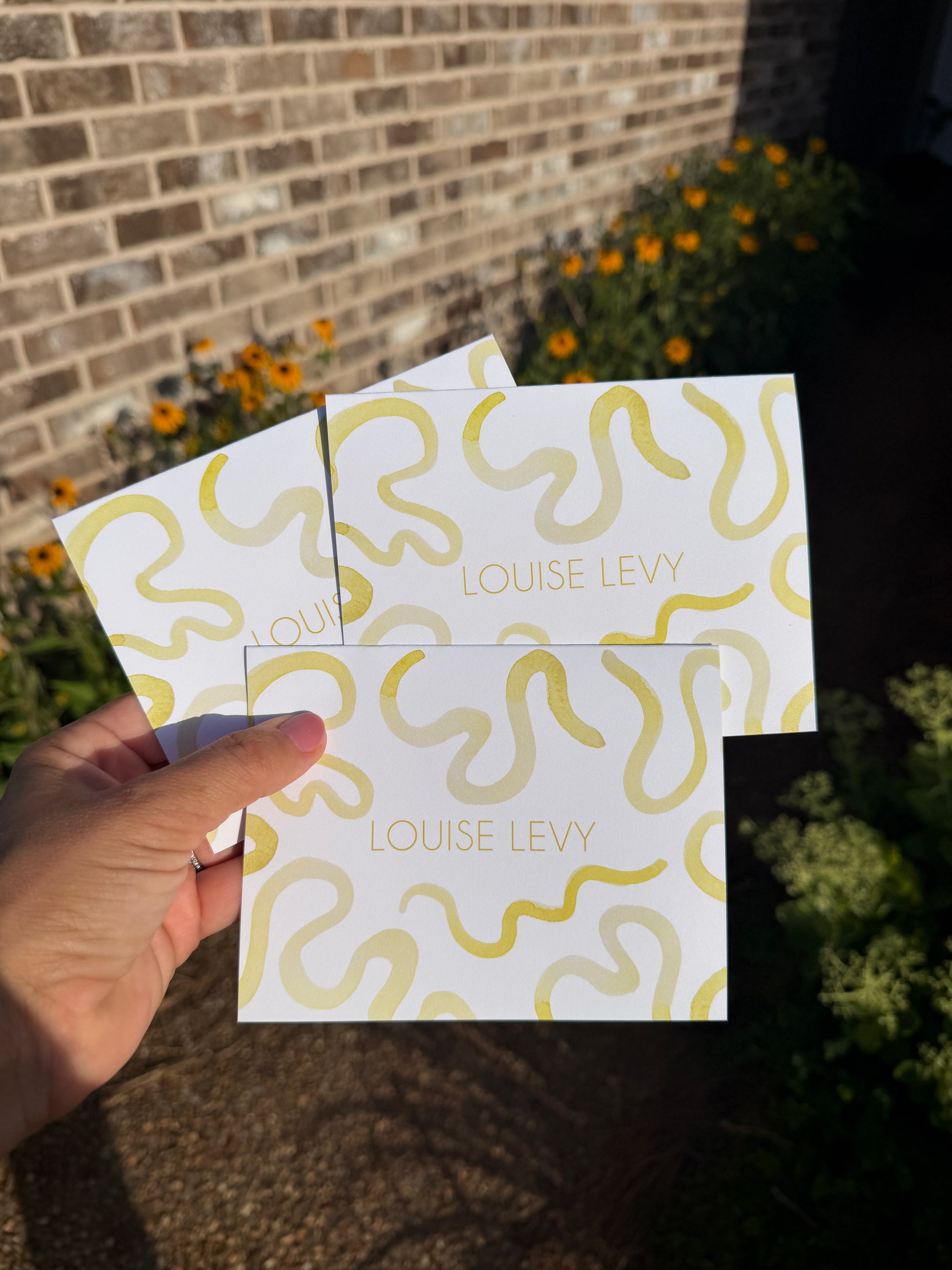 Note cards featuring yellow watercolor squiggles, with the name "Louise Levy" in lettering style #3, sunshine color. 