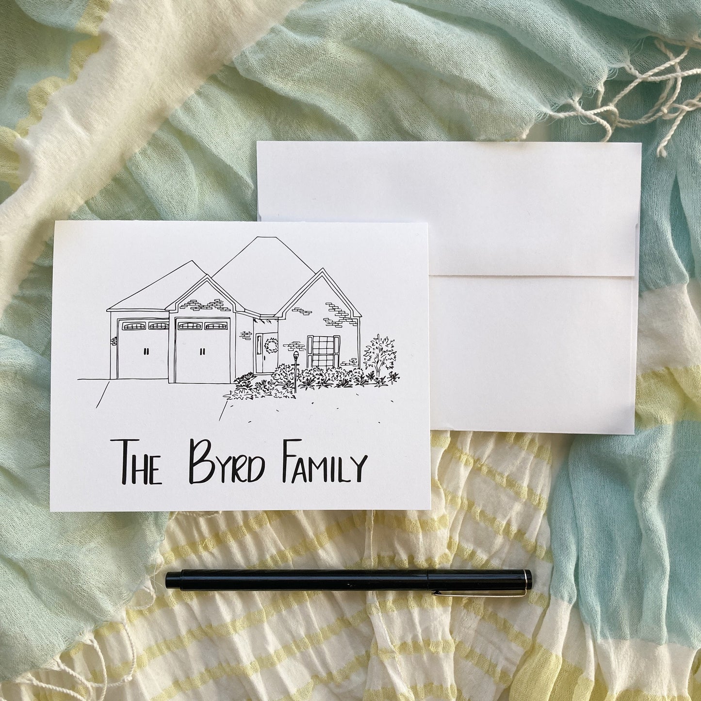 Note Card with pen and ink house drawing and hand lettered name "The Byrd Family"