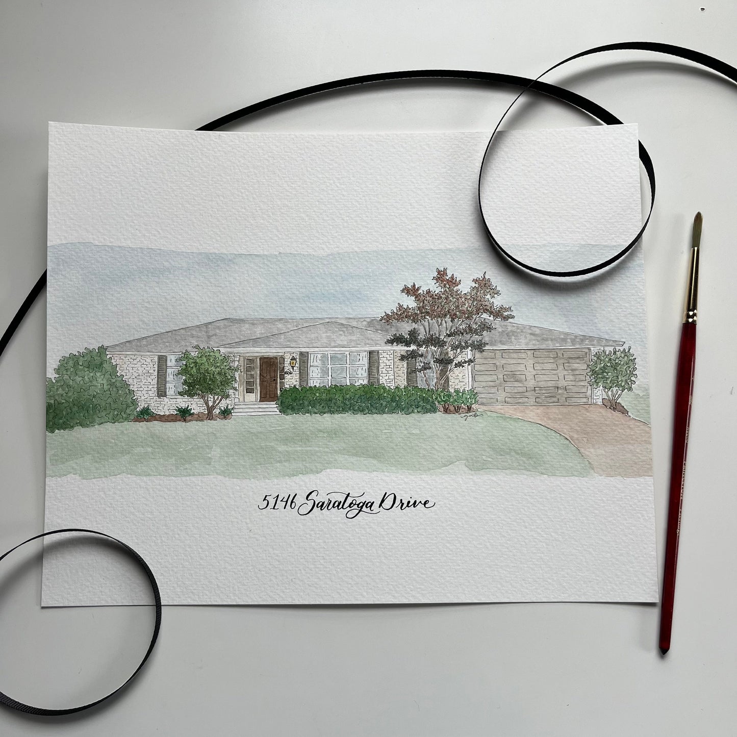 Watercolor painting of a house with address in calligraphy